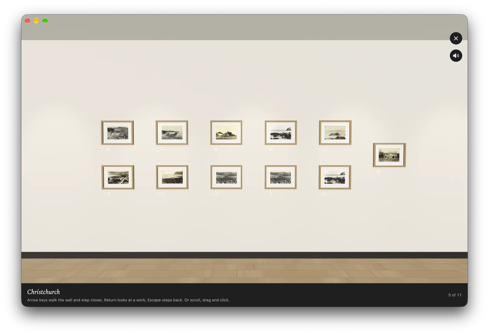 The wall in Atelier on a Mac: two rows of small framed photographs of Christchurch along a pale gallery wall above a wooden floor.